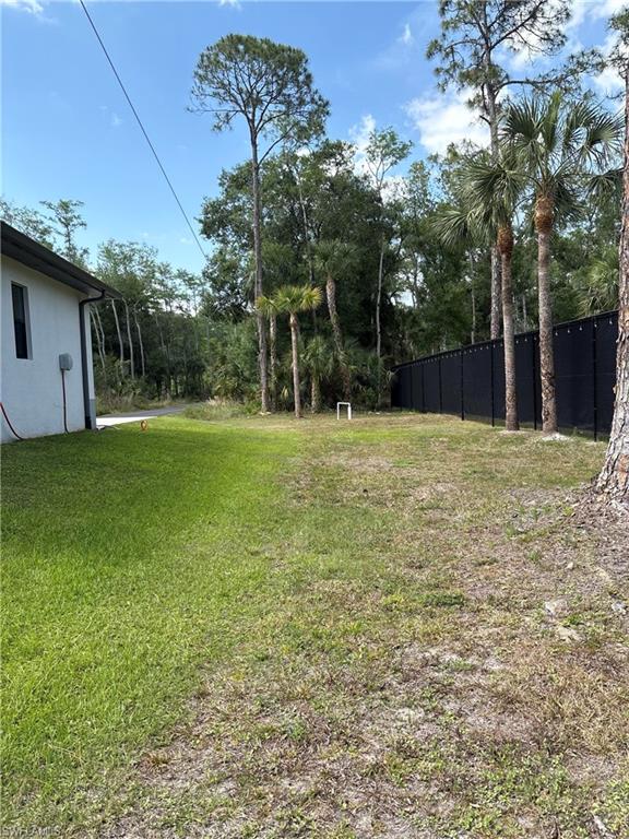 View of yard featuring fence