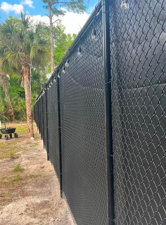 View of side of home featuring fence