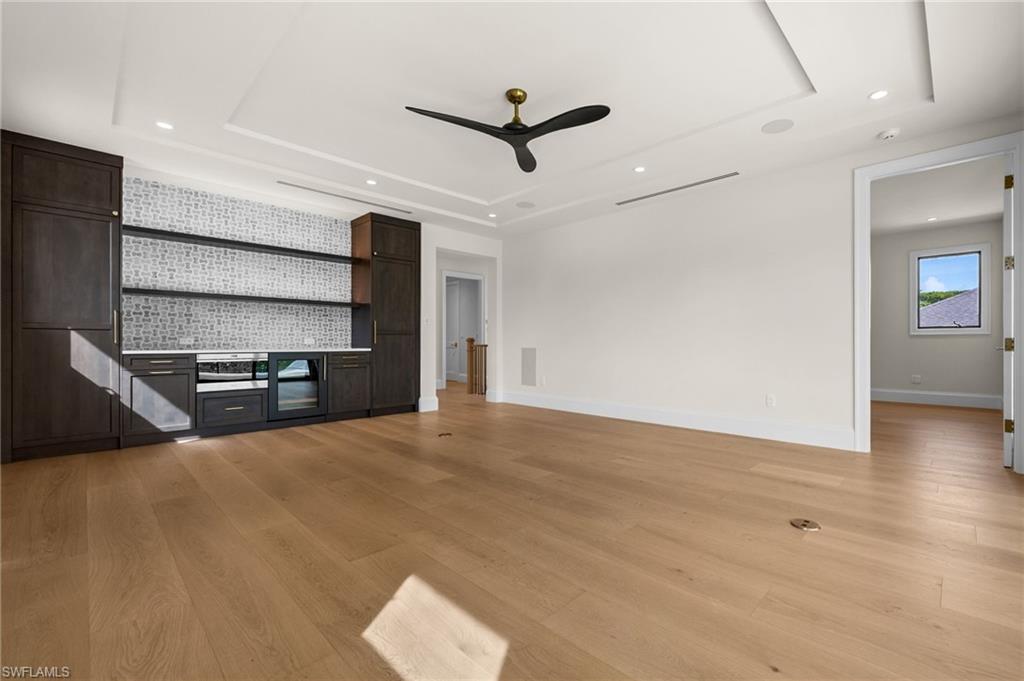 Upstairs spacious and airy loft|theater|game room with Sub-Zero bar refrigerator, Wolf microwave drawer, Pompeii upgraded countertops, coffered ceiling