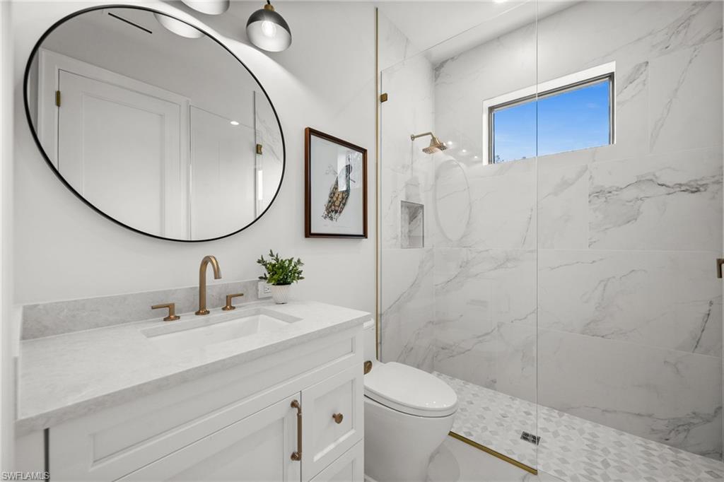 Lower level full bath in ensuite bedroom, porcelain and natural stone, Pompeii upgraded countertops