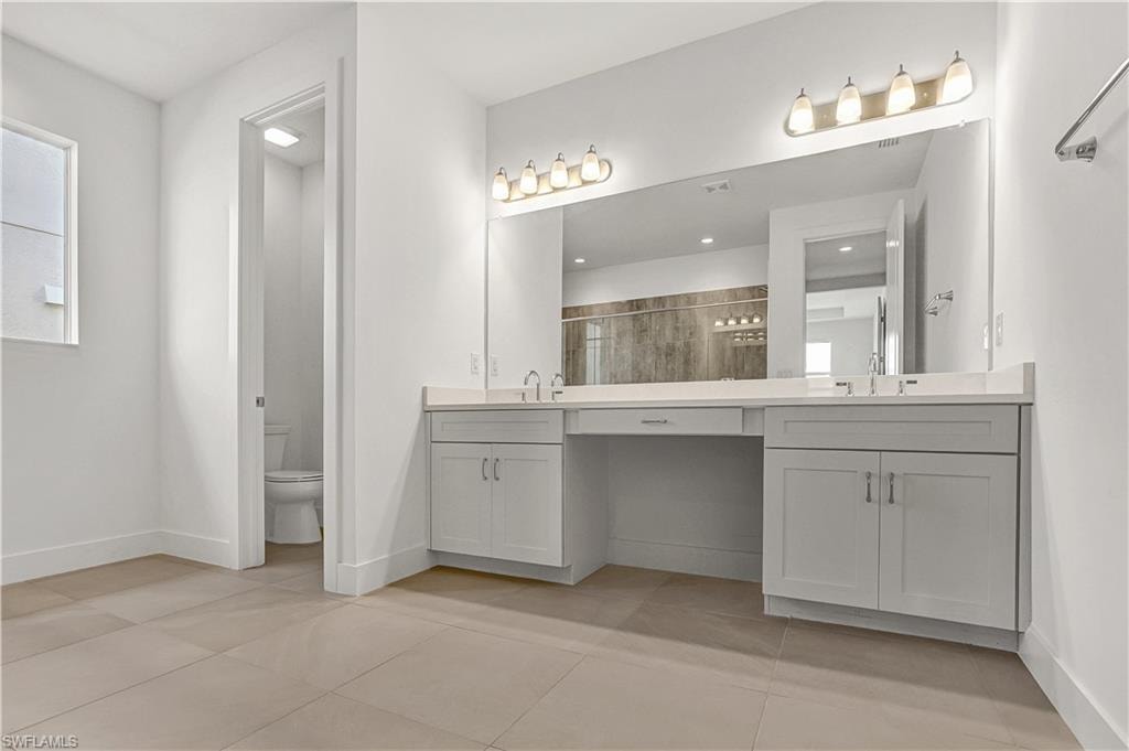 Primary bathroom with dual-sinks and quartz countertops