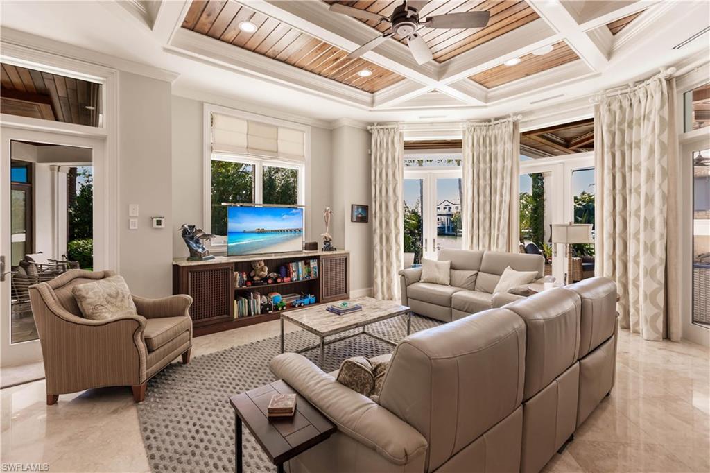 Living room with coffered ceiling, crown molding, and wooden ceiling