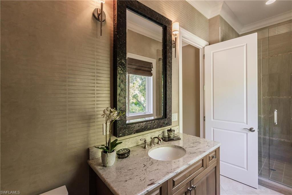 Bathroom with vanity and crown molding