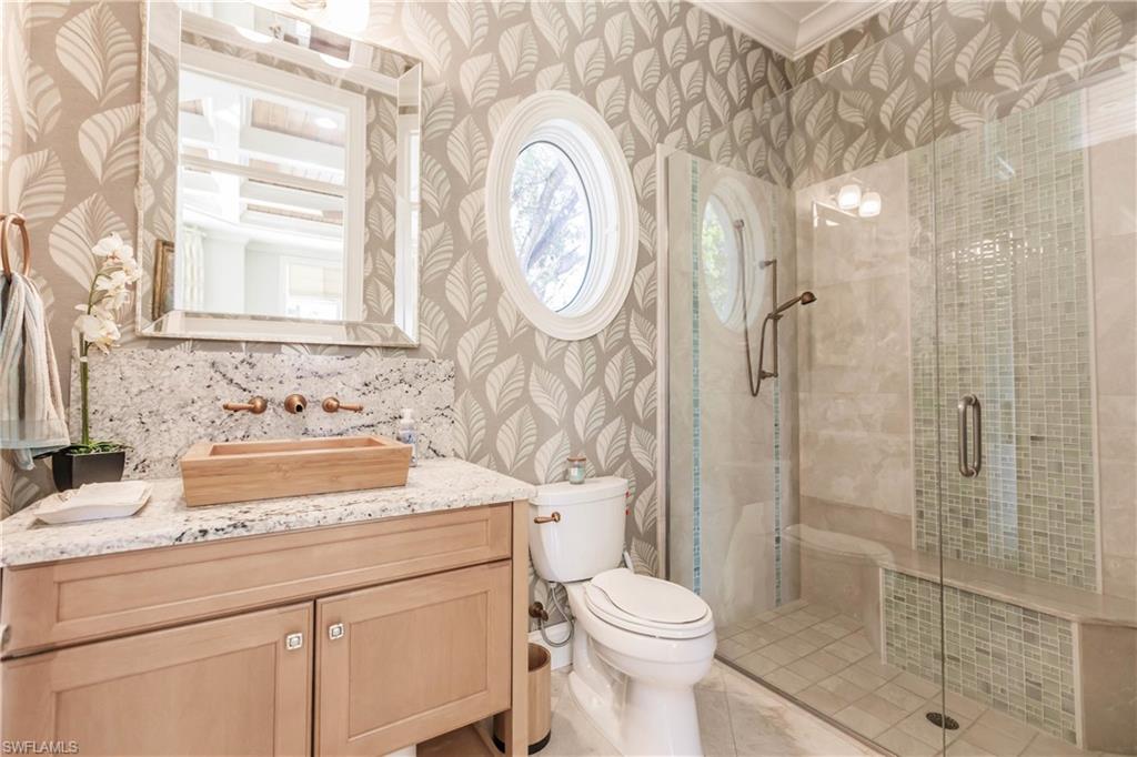 Bathroom with vanity, toilet, and walk in shower