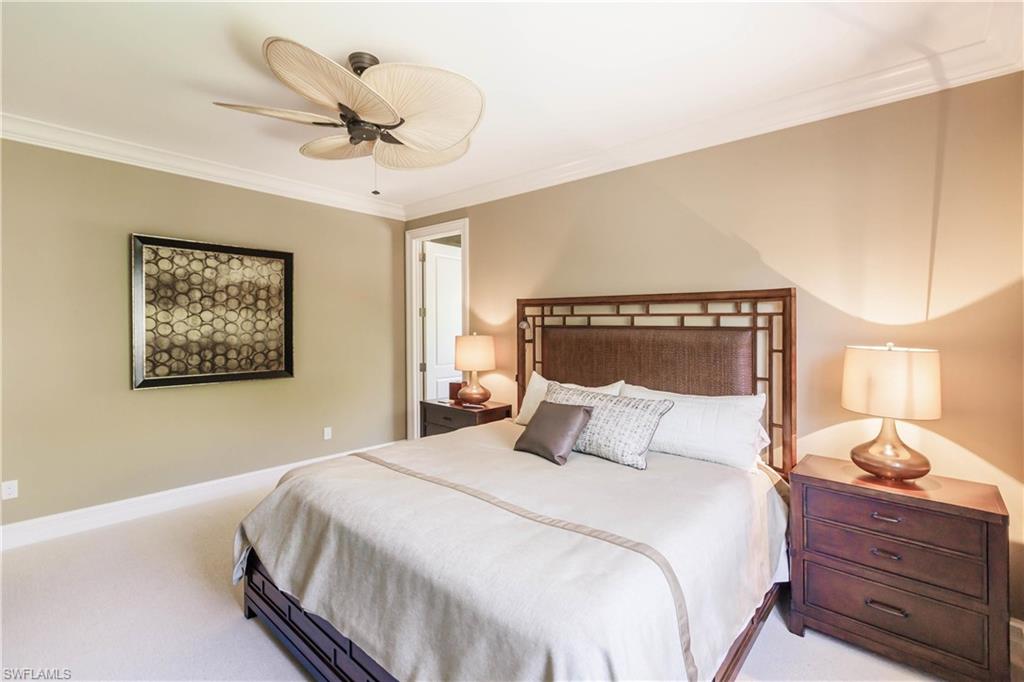 Bedroom featuring crown molding, ceiling fan, and light carpet