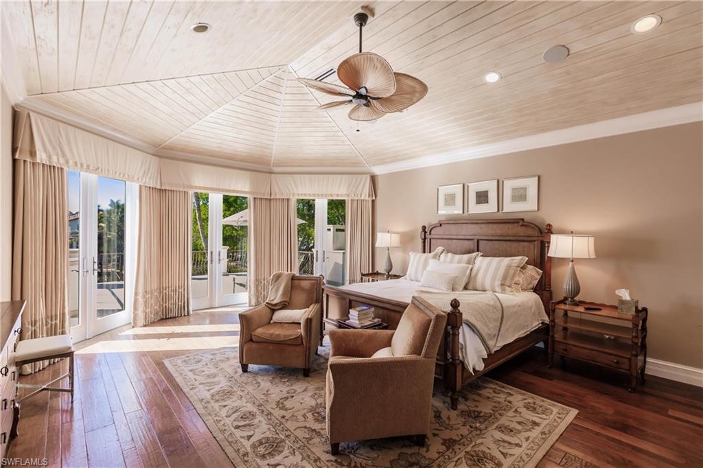 Bedroom featuring hardwood / wood-style flooring, access to exterior, ornamental molding, wooden ceiling, and french doors