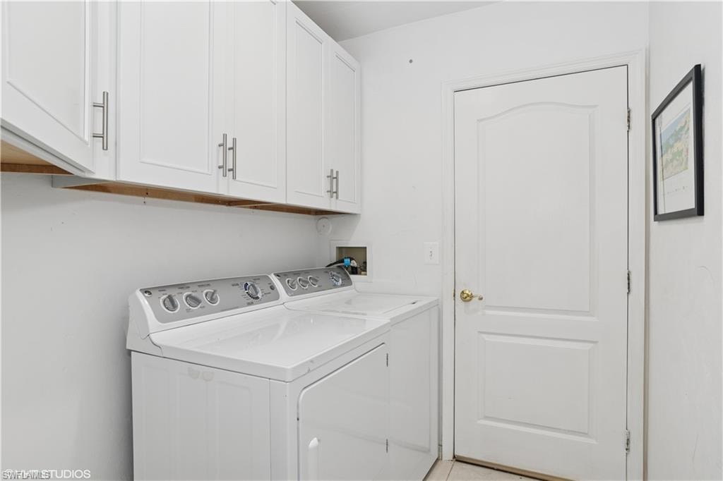 Laundry room with cabinet space and independent washer and dryer