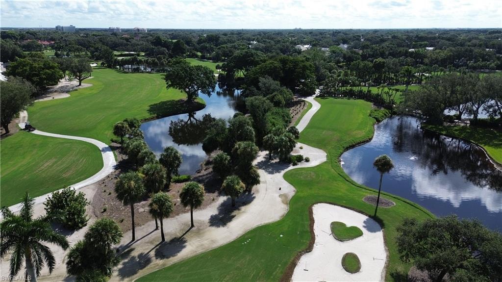 Aerial overview of property's location featuring a local golf course and a nearby body of water