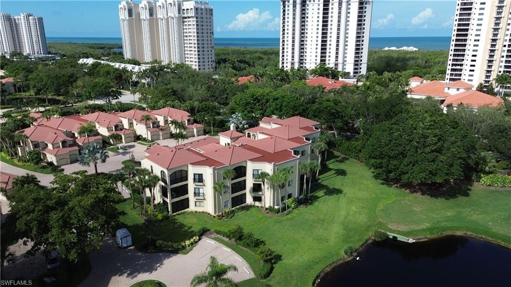 Aerial view of a large body of water and apartment complex / building