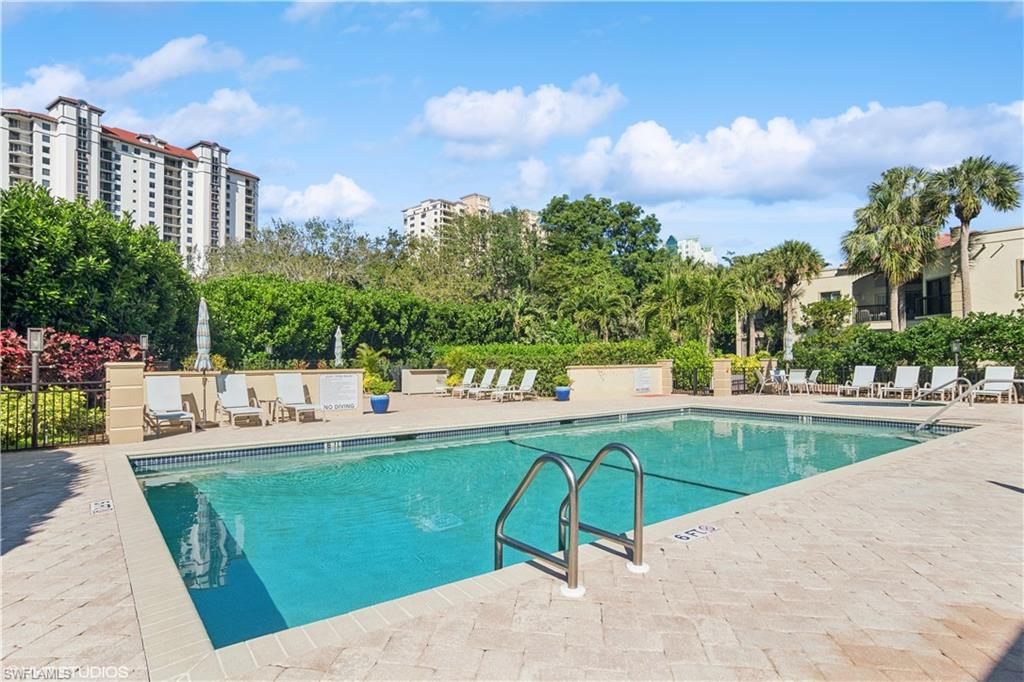 Community Pool with a patio and fence/ Hot tub