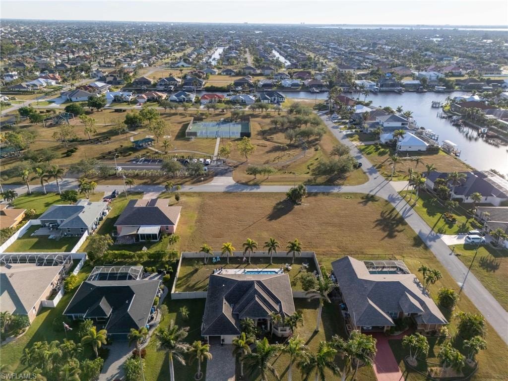 Birds eye view of property with a water view