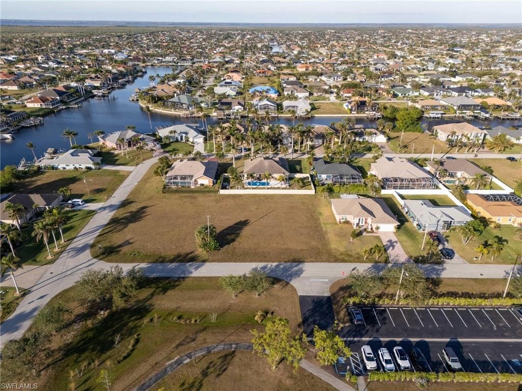 Birds eye view of property with a water view