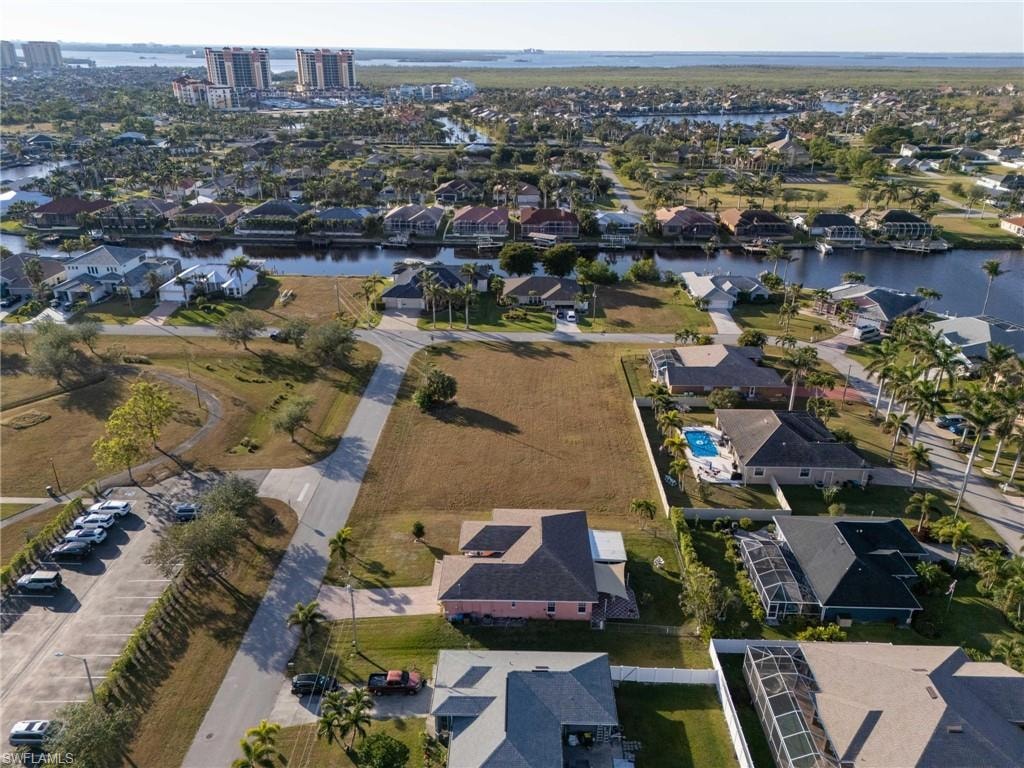 Birds eye view of property with a water view