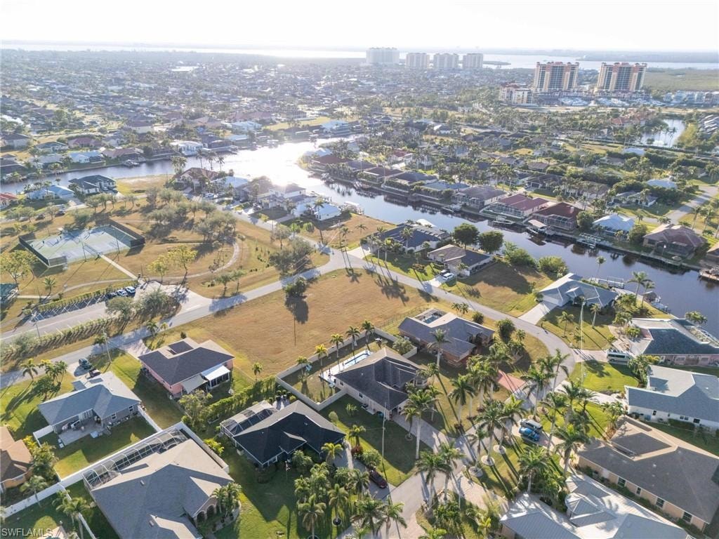 Birds eye view of property with a water view