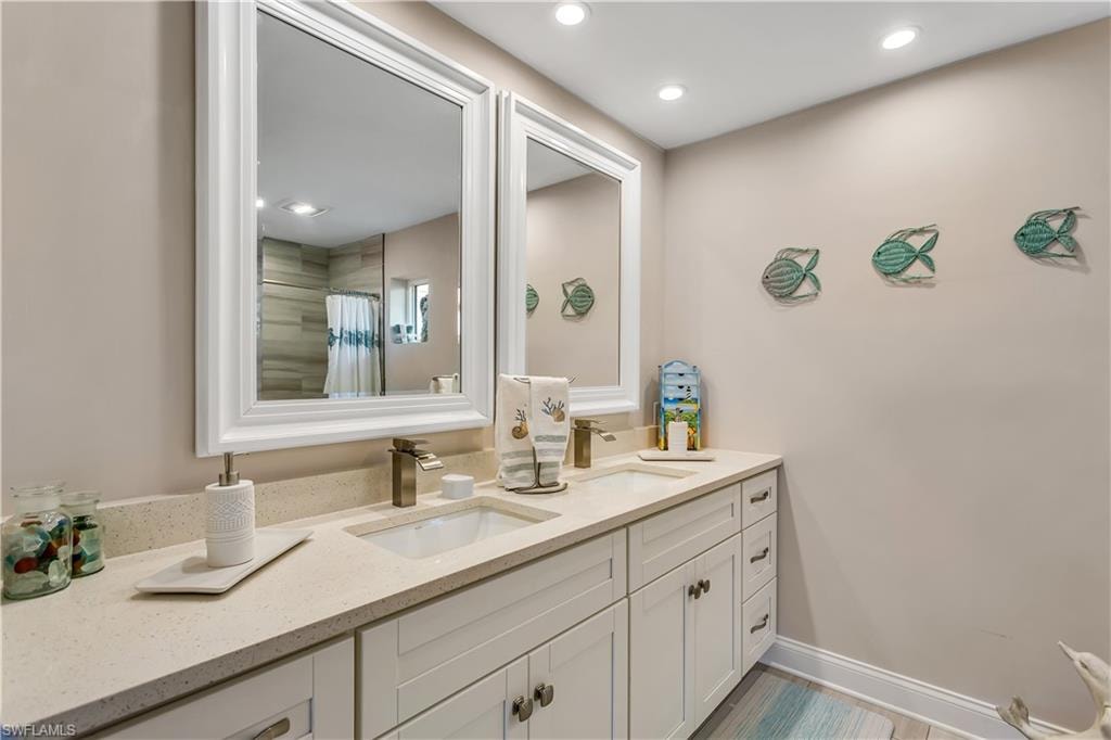 Bathroom featuring vanity and a shower