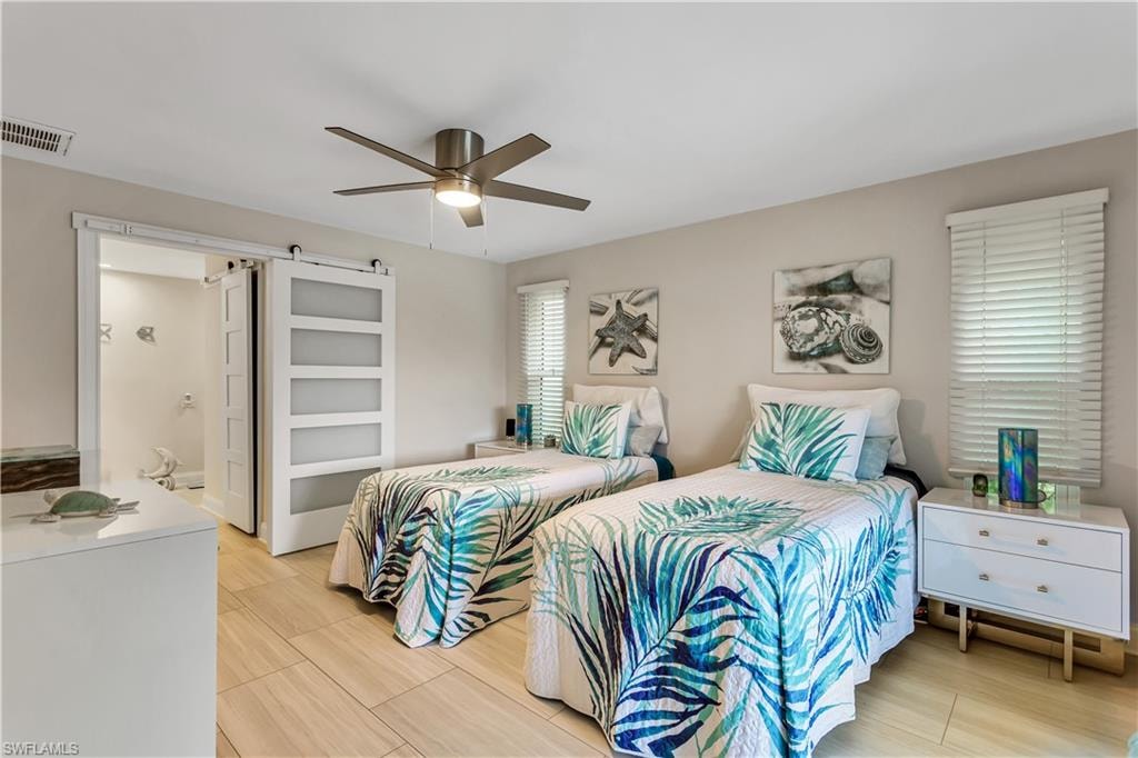 Bedroom featuring connected bathroom, ceiling fan, walk-in closet