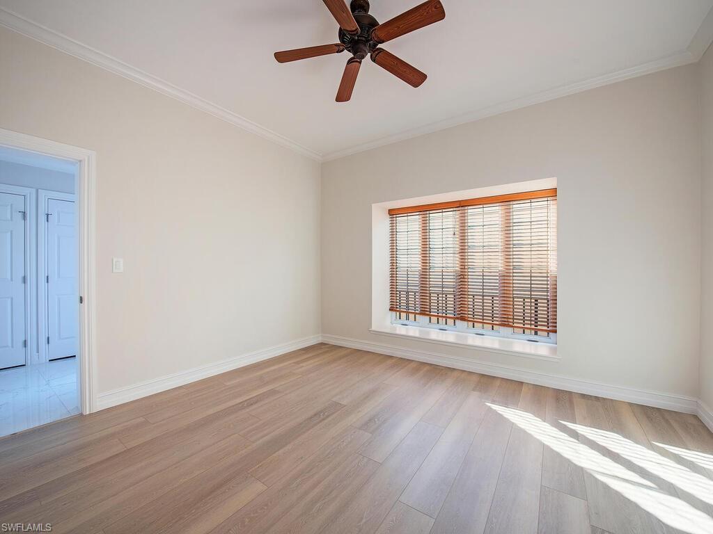 Unfurnished room with ceiling fan, light hardwood / wood-style floors, and crown molding
