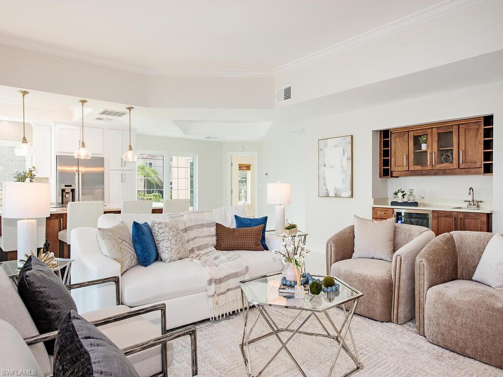Living room featuring ornamental molding and sink