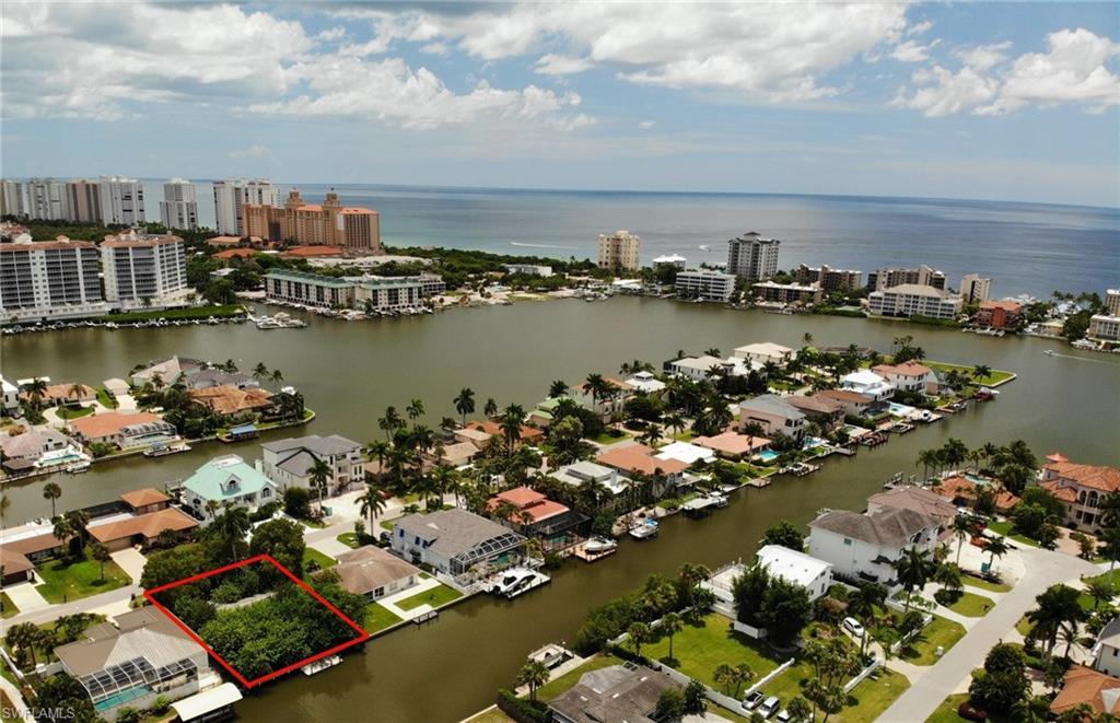 View of urban area featuring property parcel outlined and a large body of water