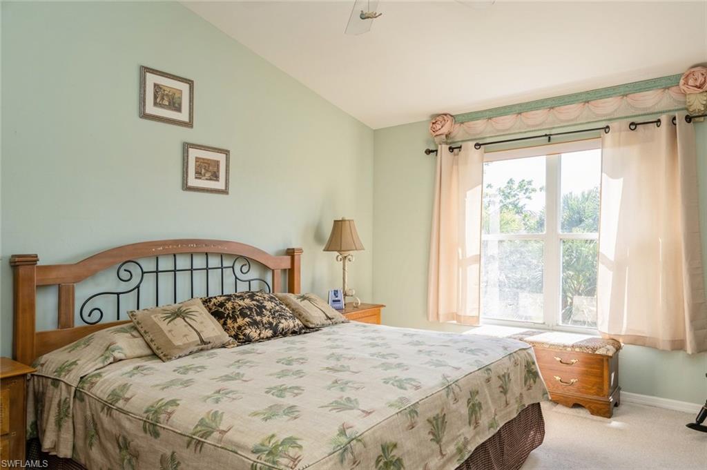 Carpeted bedroom with lofted ceiling