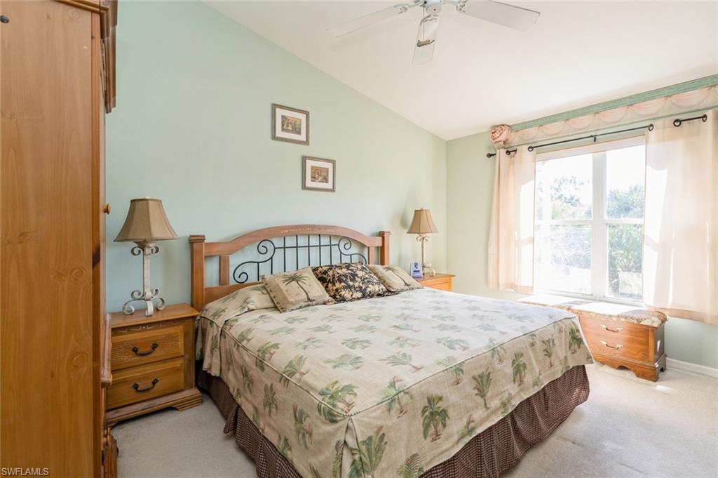 Bedroom featuring light colored carpet, ceiling fan, and lofted ceiling