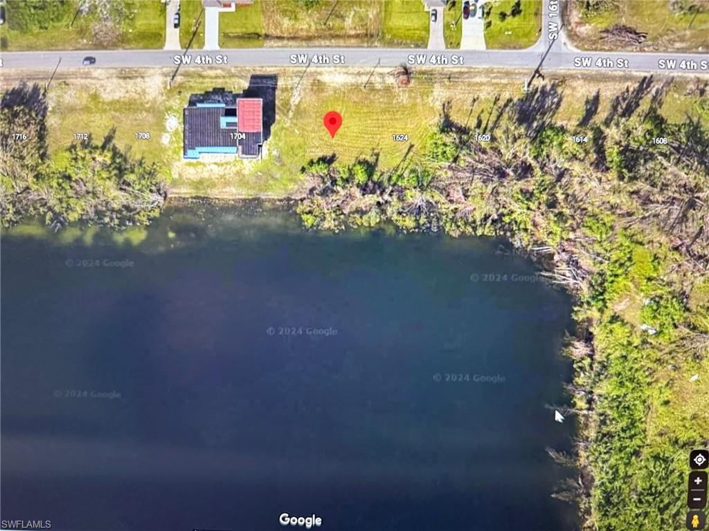 Birds eye view of property with a water view