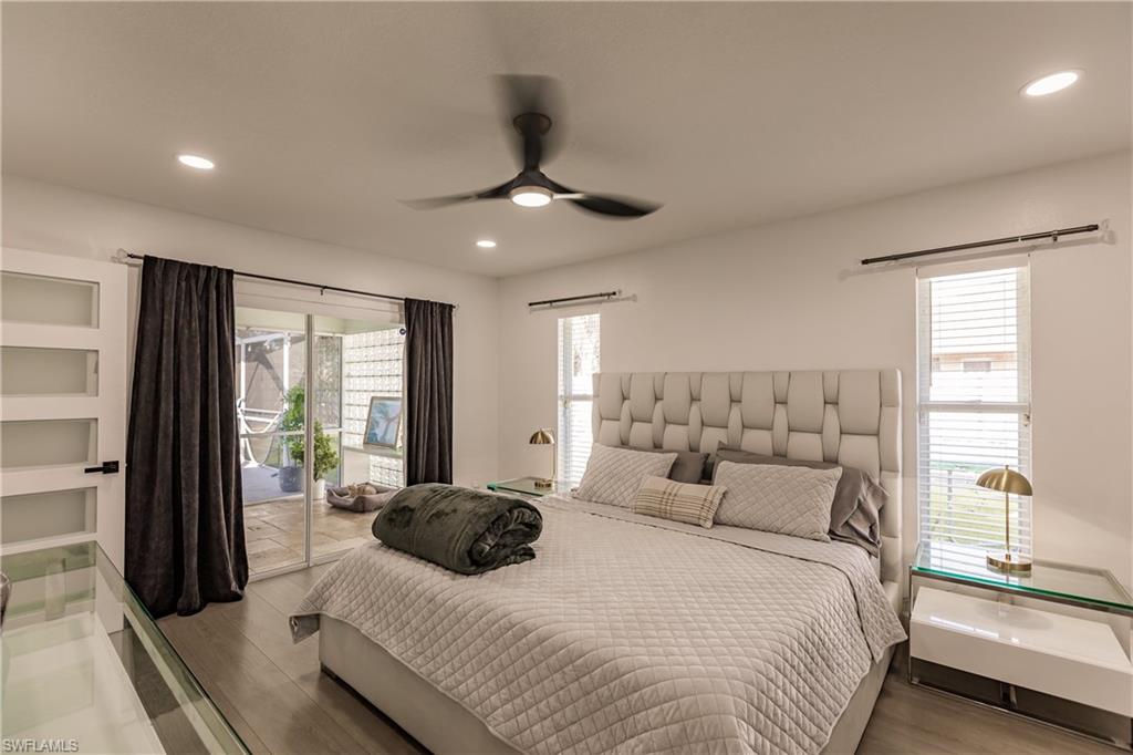Bedroom with access to exterior, ceiling fan, and light hardwood / wood-style floors