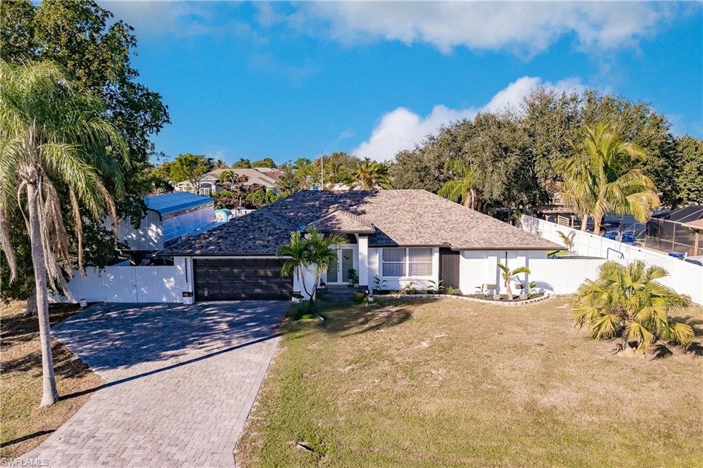 View of front of property with a garage and a front yard
