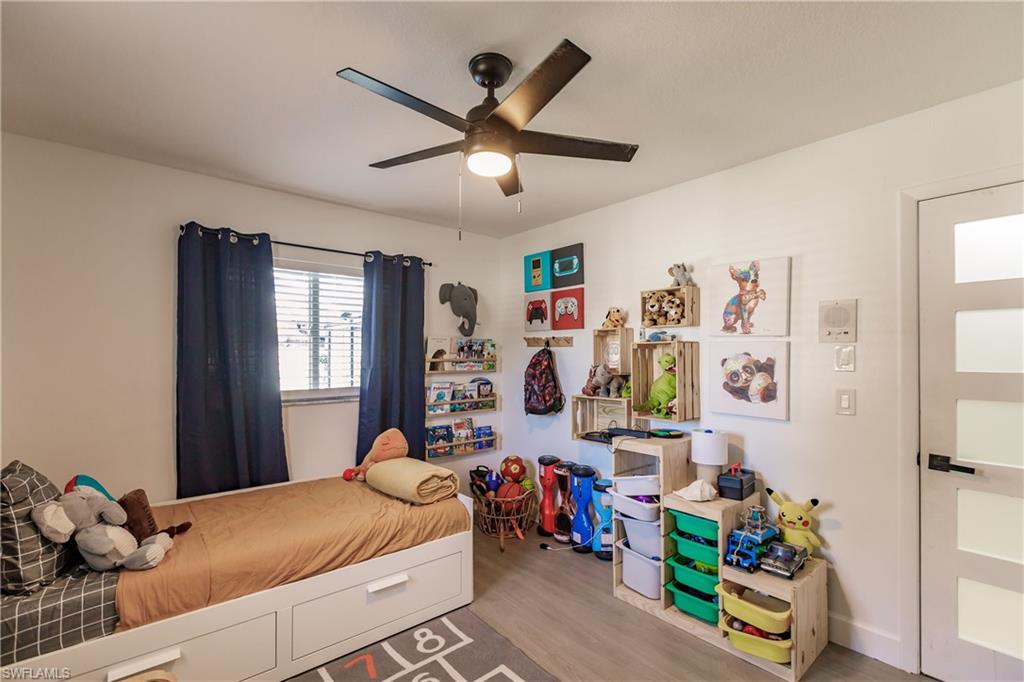 Bedroom featuring ceiling fan and hardwood / wood-style floors