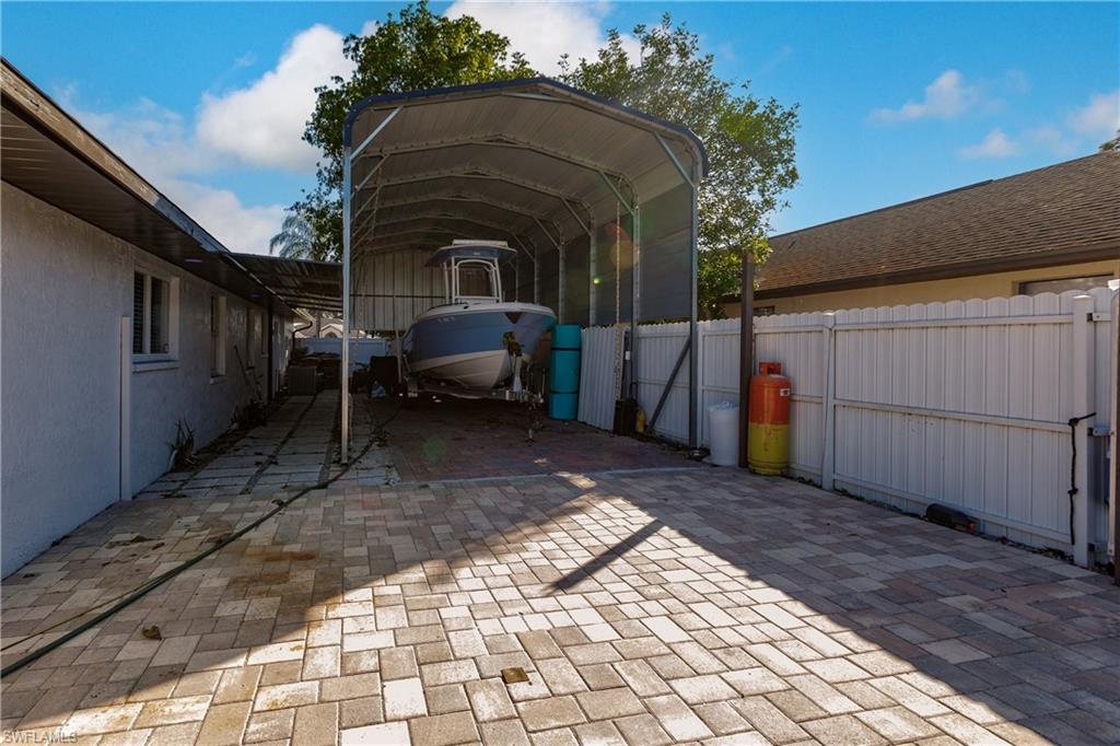 View of parking featuring a carport