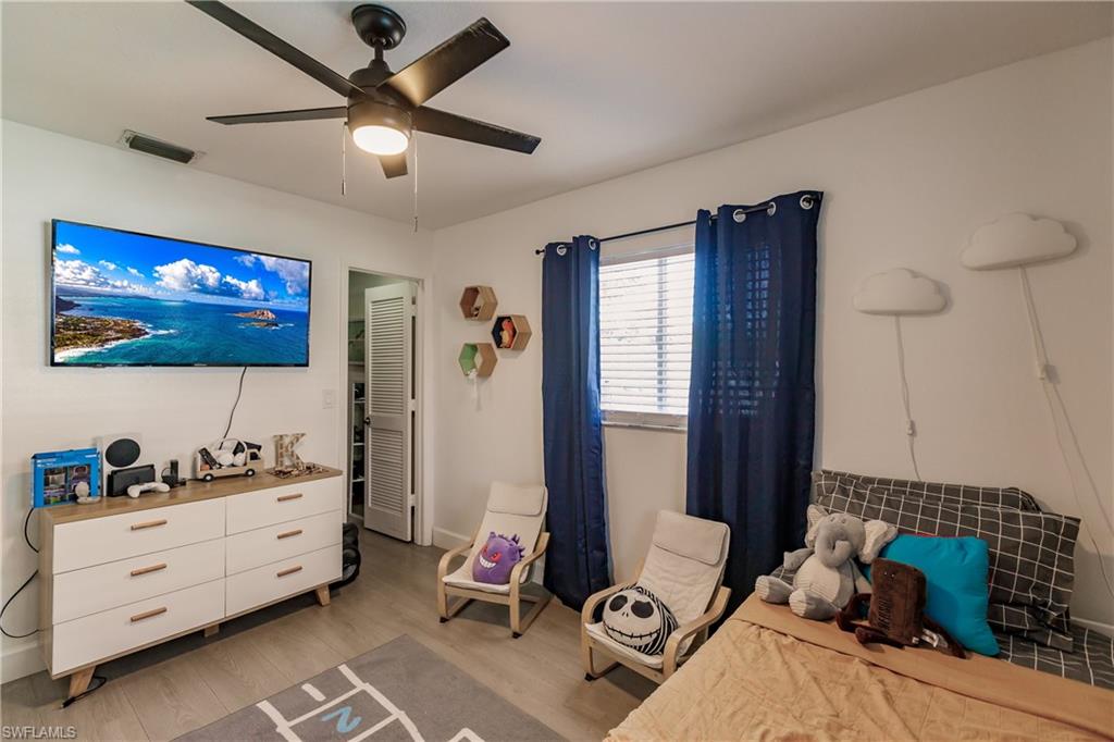 Bedroom featuring ceiling fan and light hardwood / wood-style flooring