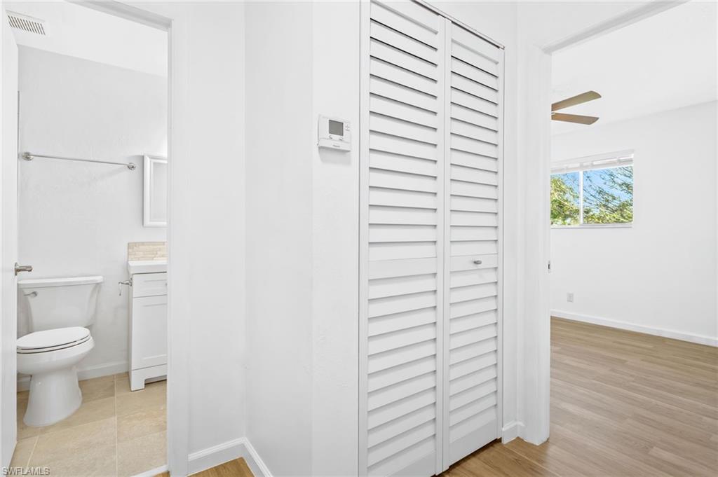 Bathroom featuring LVP wood-style floors, vanity, and toilet