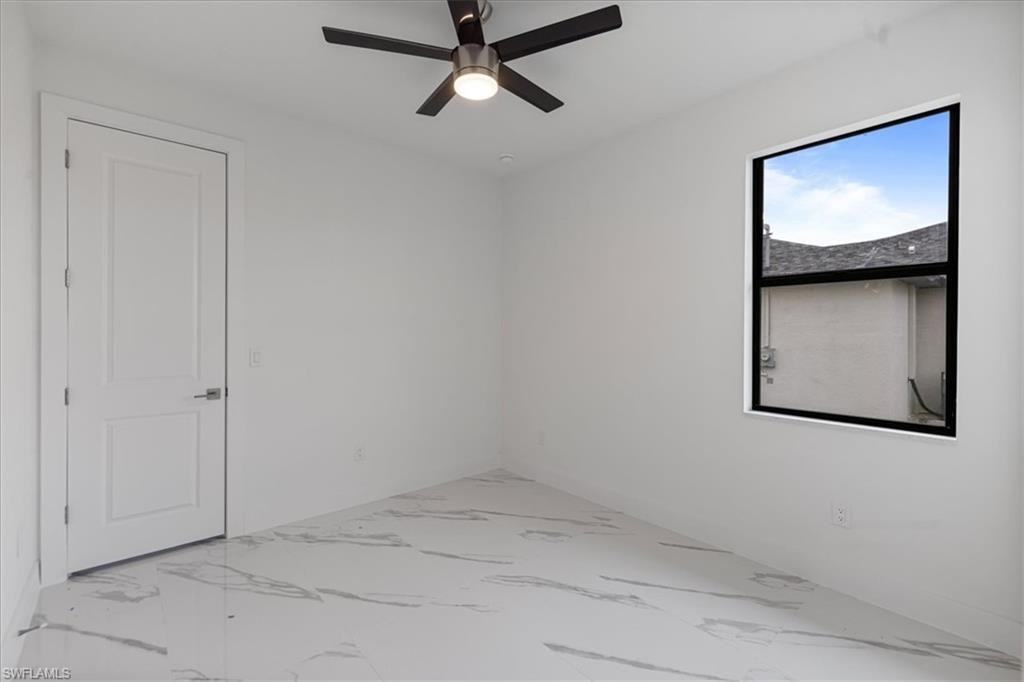 Empty room featuring ceiling fan
