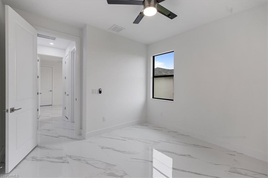 Spare room with ceiling fan