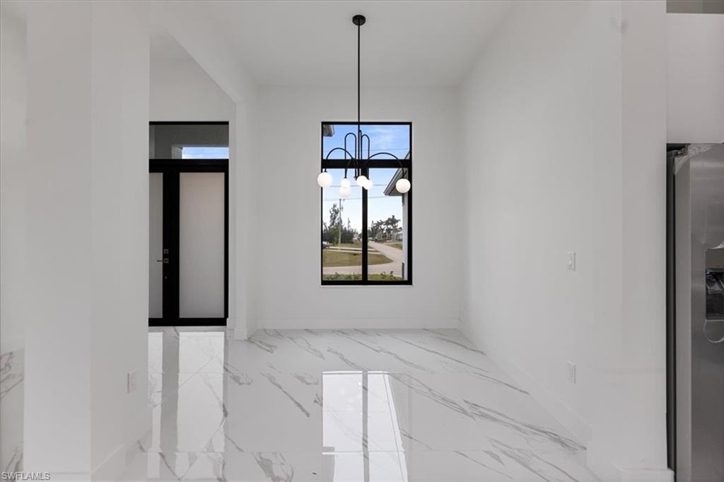 Unfurnished dining area featuring a chandelier