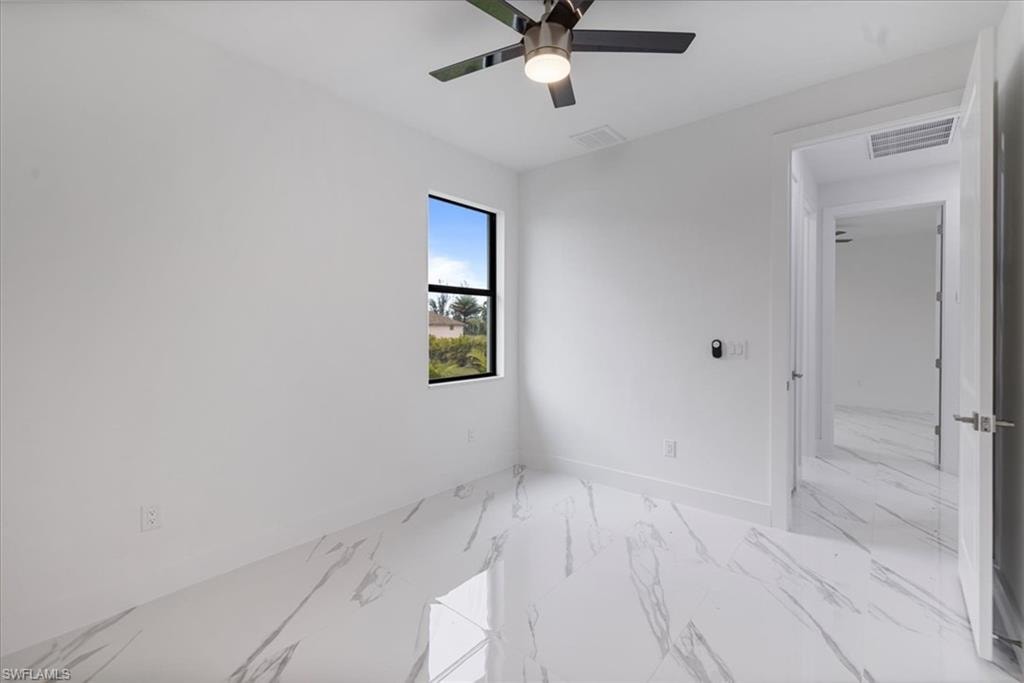 Empty room featuring ceiling fan