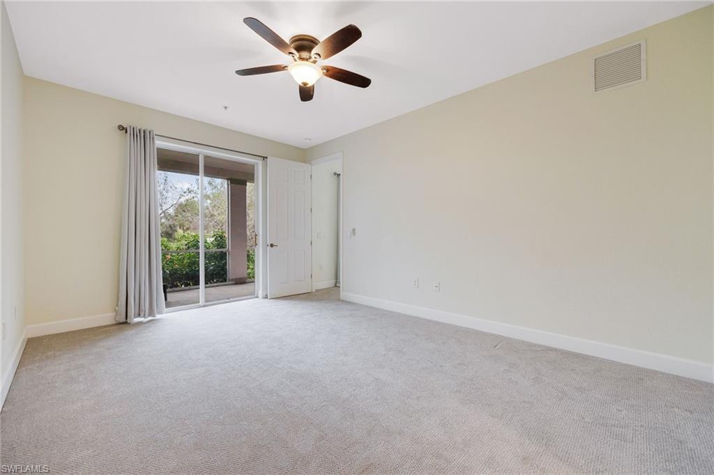 Empty room with light colored carpet and ceiling fan