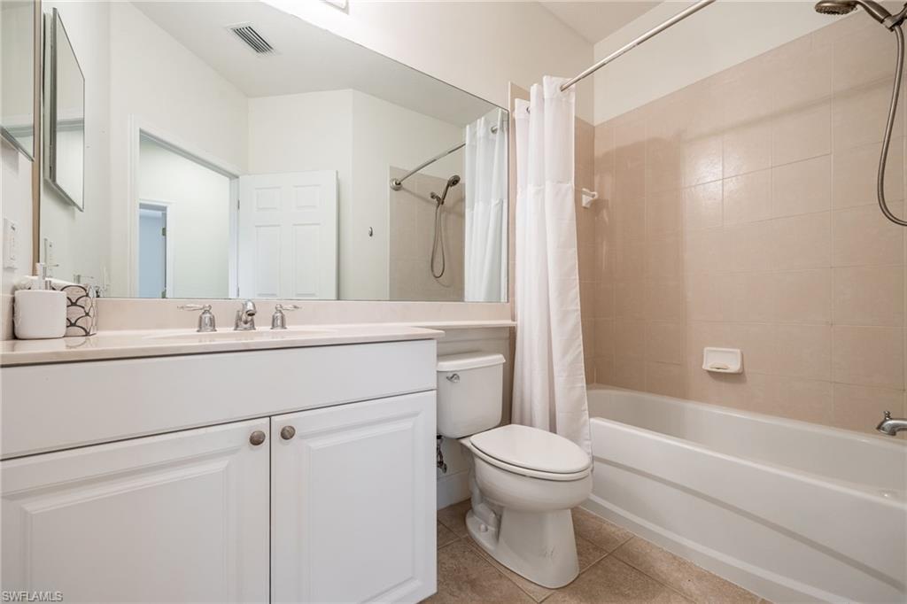 Full bathroom featuring vanity, toilet, shower / tub combo, and tile patterned flooring