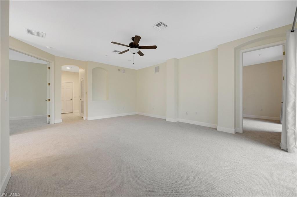 Spare room featuring ceiling fan and light carpet