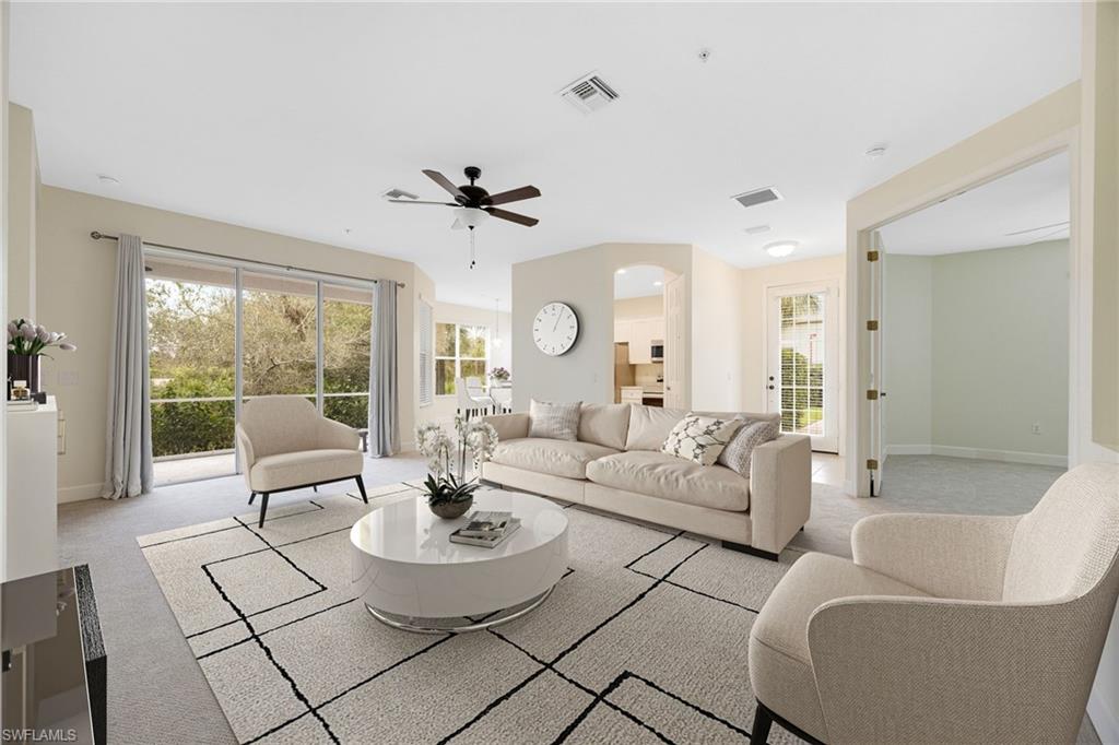 Living area with light colored carpet and a ceiling fan