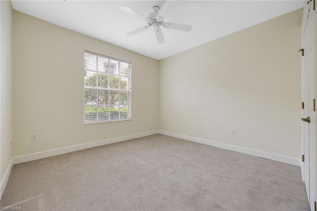Empty room featuring ceiling fan and light colored carpet
