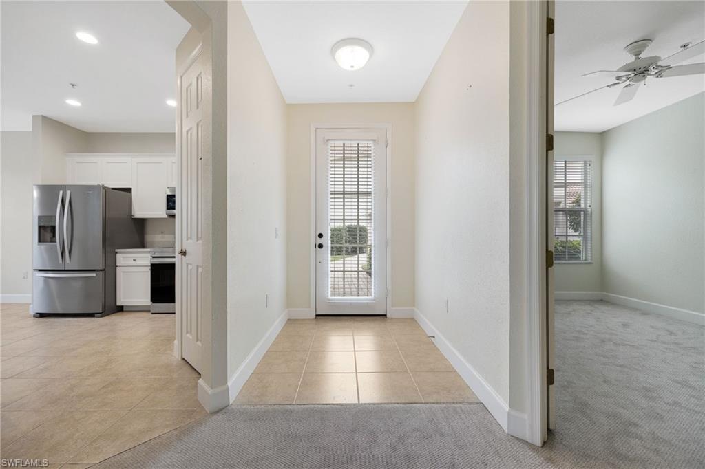 Tiled entrance foyer featuring ceiling fan