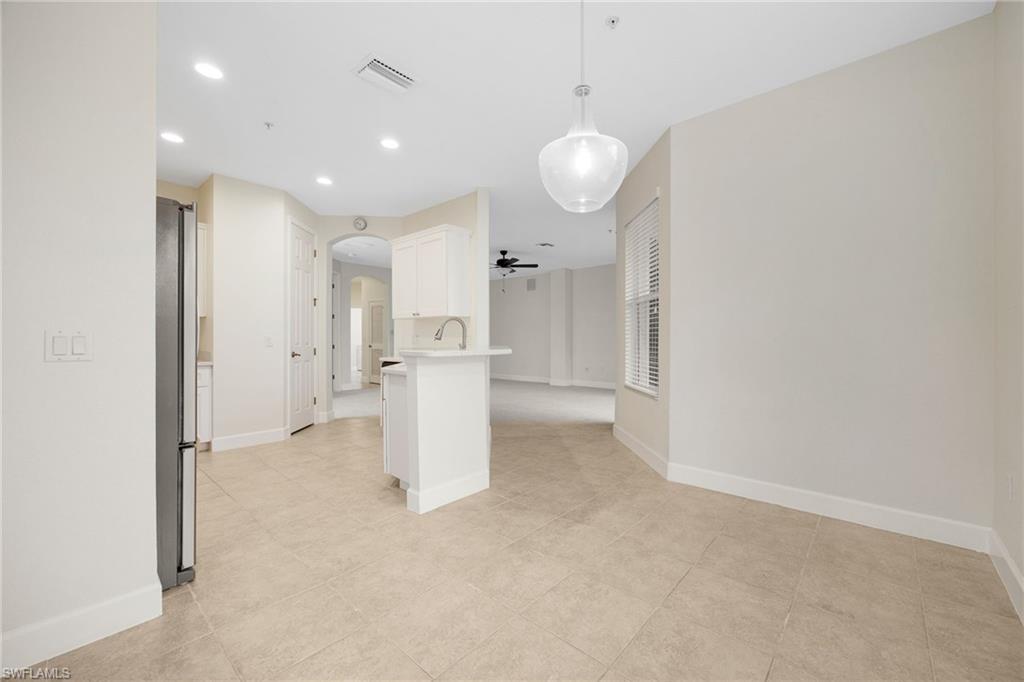 Tiled empty room with sink and ceiling fan