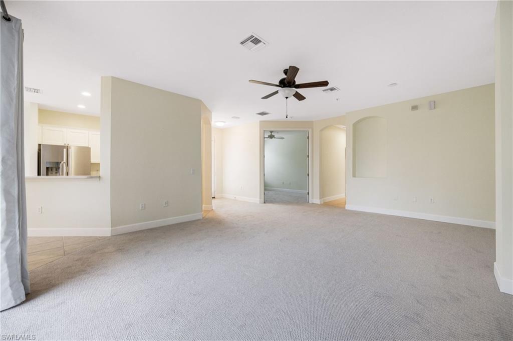 Carpeted spare room with ceiling fan
