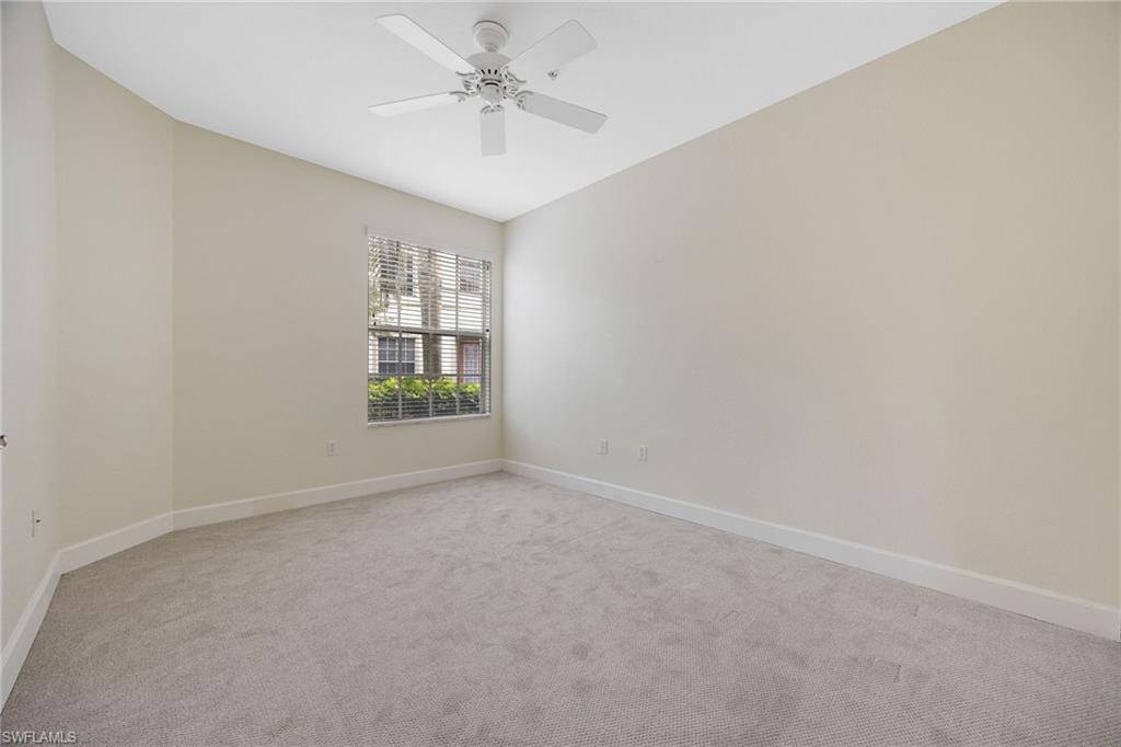 Carpeted spare room with ceiling fan