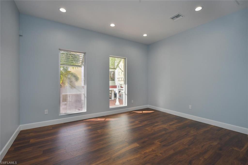 Empty room featuring dark wood-type flooring