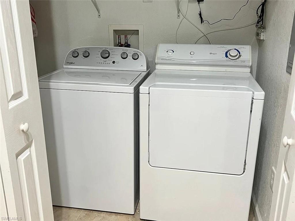 Laundry room with washing machine and clothes dryer
