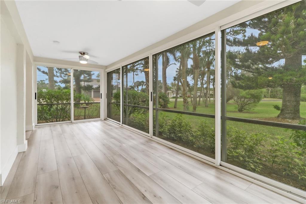 Unfurnished sunroom with ceiling fan and plenty of natural light