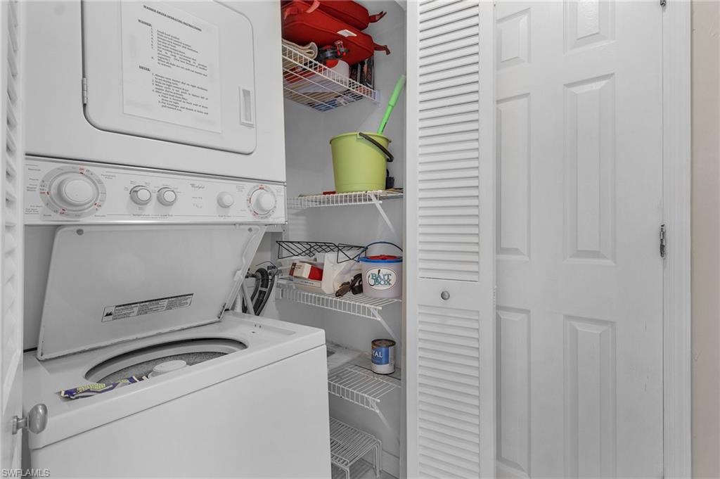 Clothes washing area featuring stacked washer and dryer