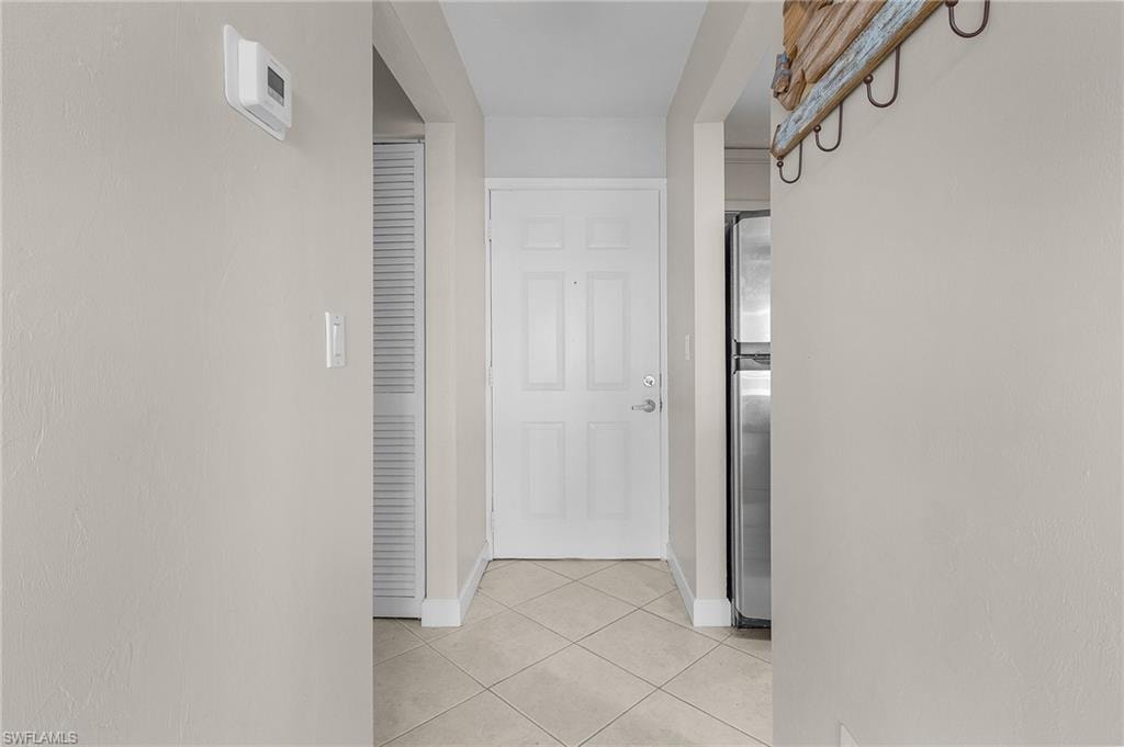 Corridor with light tile patterned floors